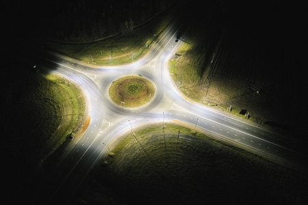 Empty roundabout at night light aerial above drone view