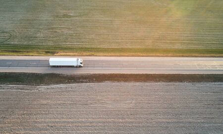White lorry truck on green landscape background aerial drone viewの写真素材