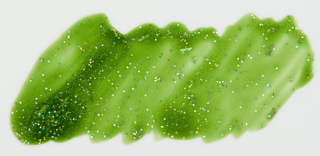 Sparkle green paint stain isolated on white background close up view