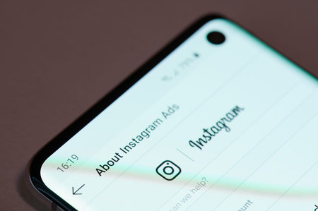 New york, USA - december 17, 2019: Using instagram ads on smartphone screen close up view