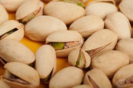 Close up of dry group pistachio on yellow background