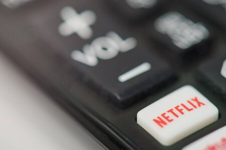 New-York , USA - February  11, 2020: Netflix button on tv remote macro close up viewのeditorial素材