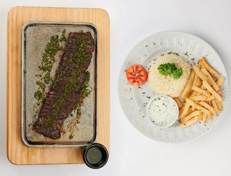 Churrasco meat plate with rice and fries isolated above top viewの写真素材