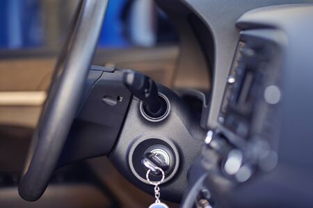 Key in car ignition with steering wheel side viewの写真素材