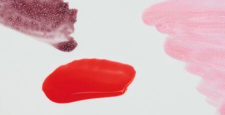 Glossy red  paint stroke isolated on white background close up viewの写真素材