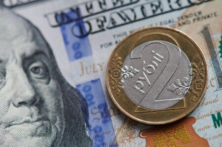 Belarusian coin on dollar banknote bill close up viewの写真素材