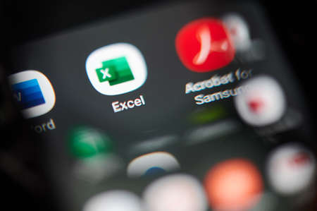 New-York , USA - March 13, 2020: Microsoft excel application icon view throw magnifier  close upのeditorial素材