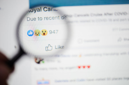 New-York , USA - March 13, 2020: Sorry reaction on facebook post on laptop close up view