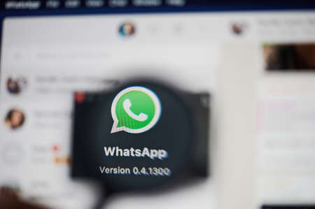 New-York , USA - March 13, 2020: Whatsapp messenger application icon view throw magnifier  close upのeditorial素材