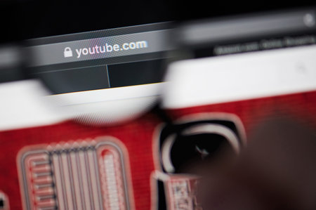 New-York , USA - March 13, 2020: Youtube address in browser view throw magnifier  close up
