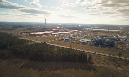 Heavy industrial production plant on sunny day aerial above drone view