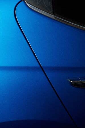 Long  paint dents  on blue car body close up viewの写真素材