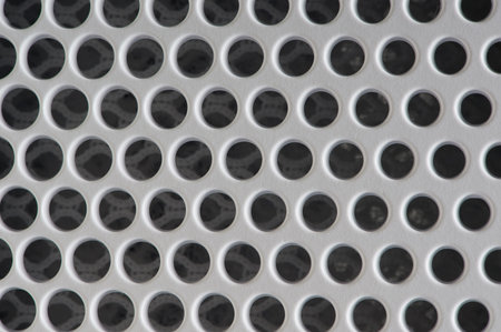 Pattern of vent holes. White plastic mesh barrier 