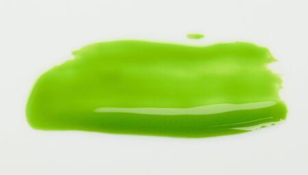 Light green glossy paint stroke isolated on white background close up viewの写真素材