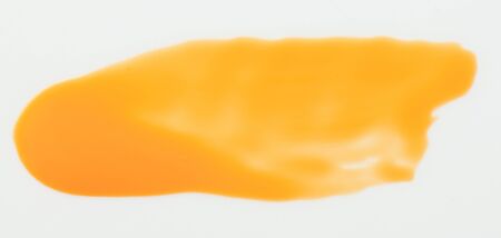 Yellow paint stroke isolated on white background close up viewの写真素材