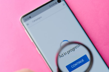 New-York , USA - June 4 , 2020: Using google ad  app on modern smartphone throw magnifier close up...