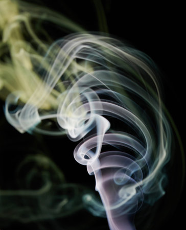 Transparent colorful smoke swirl with smooth shape in black backdground