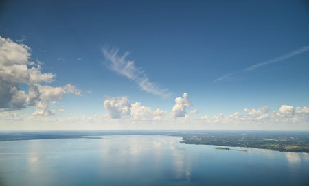 Blue color lake with cloudscape aerial drone view