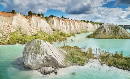 Quarry with green water and rocks aerial above drone viewの写真素材