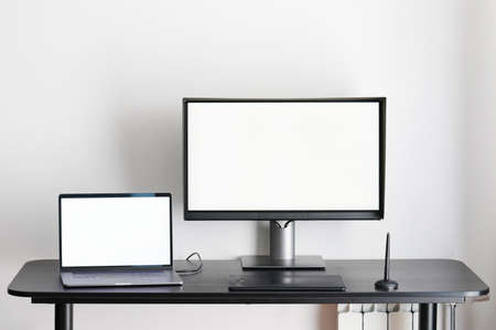 Desk with laptop and computer monitor on office spaceの写真素材