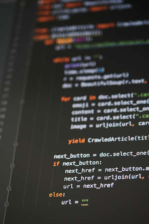 New york, USA - September 13, 2020: Coding text on black vertical background computer screen close up viewのeditorial素材