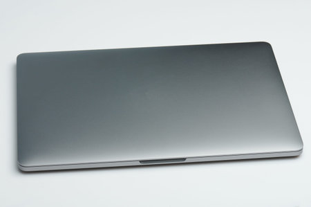Gray closed metal laptop isolated on white studio background