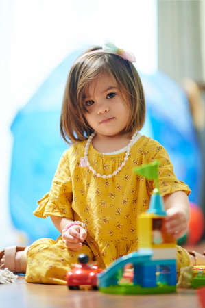 Girl kid play with colorful bricks  in kindergarten. Kid day careの写真素材