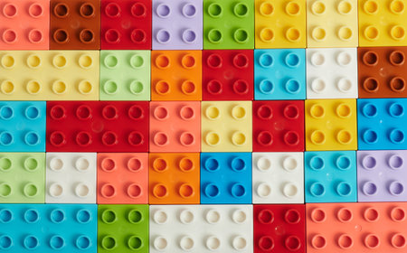 Flat background of plastic colorful bricks above top view