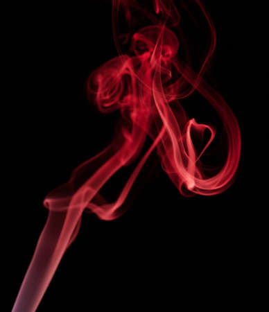 Abstract smoke swirls red color on black background. Elegant colorful curves wallpaper. Flow of transparent waveの写真素材
