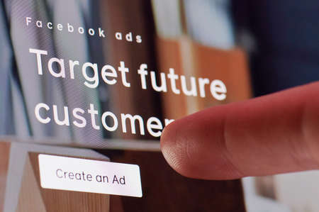 New york, USA - October 27, 2020: Creating ads in facebook service touching screen display close up viewのeditorial素材