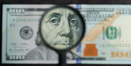 Face of Franklin president on us dollar banknote through magnifier viewの写真素材