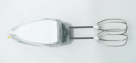 White modern  hand mixer isolated on studio background