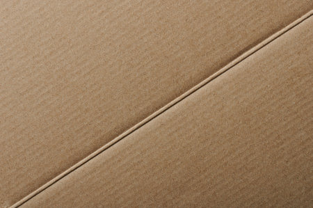 Diogonal bend line on carton paper background macro close up viewの写真素材