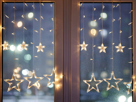 Twinkle glitter christmas window ornament  on bluured evening backgroundの写真素材