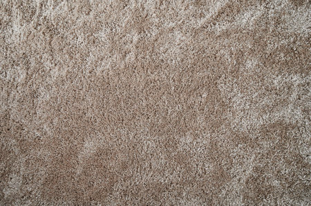 Light brown fluffy background. Surface of wool beige color rugの写真素材