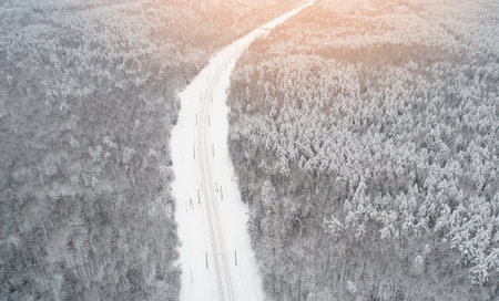 Railraod with electric cable in winter forest background aerial viewの写真素材