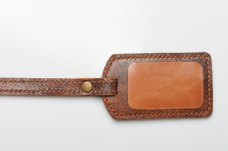 Brown leather tag with copy space isolated on white studio backgroundの写真素材