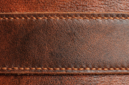 Brown leather tag with stitches macro close up viewの写真素材