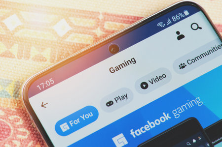 New york, USA - January 26, 2021: Facebook gaming menu on smartphone screen close up view. Watching game videos themeのeditorial素材