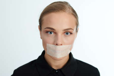 Headshot of woman with covered mouth. Censorship themeの写真素材