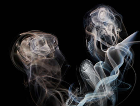 Brown smoke curles on black background. Transparent wavy smooth backdropの写真素材
