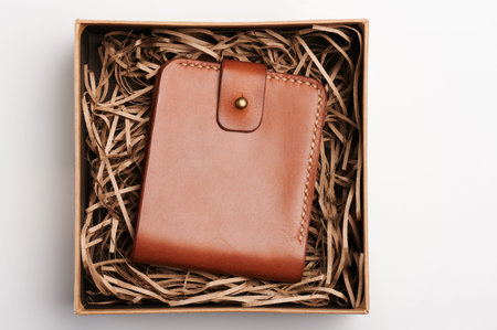 Luxury leather brown color wallet in paper box in soft above top viewの写真素材