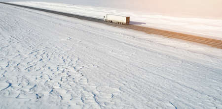 Lorry truck carry cargo on snow background aerial drone viewの写真素材