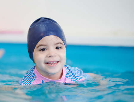 Portrait of child in swim suit in pool water close up viewの写真素材