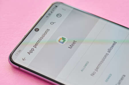 New york, USA - April 23, 2021: Changing permissions setting of google meet app on smartphone screen macro close up viewのeditorial素材