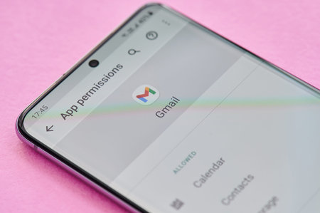 New york, USA - April 23, 2021: Changing permissions setting of gmail app on smartphone screen macro...
