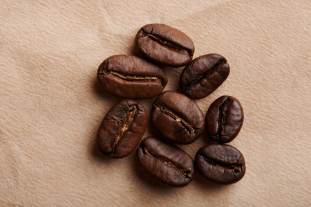 Group of roasted coffee beans on brown paper background
