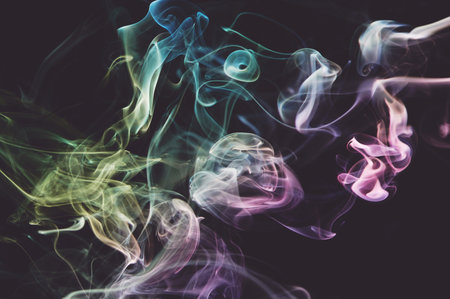 Flowing abstract shape air colorful smoke on dark grey backgroundの写真素材