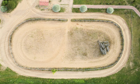 Empty sand hippodrome above top drone view in rural area