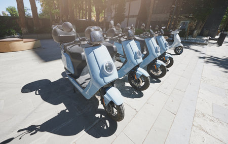 Row of moto scooters parked for rent in street on sunny dayのeditorial素材